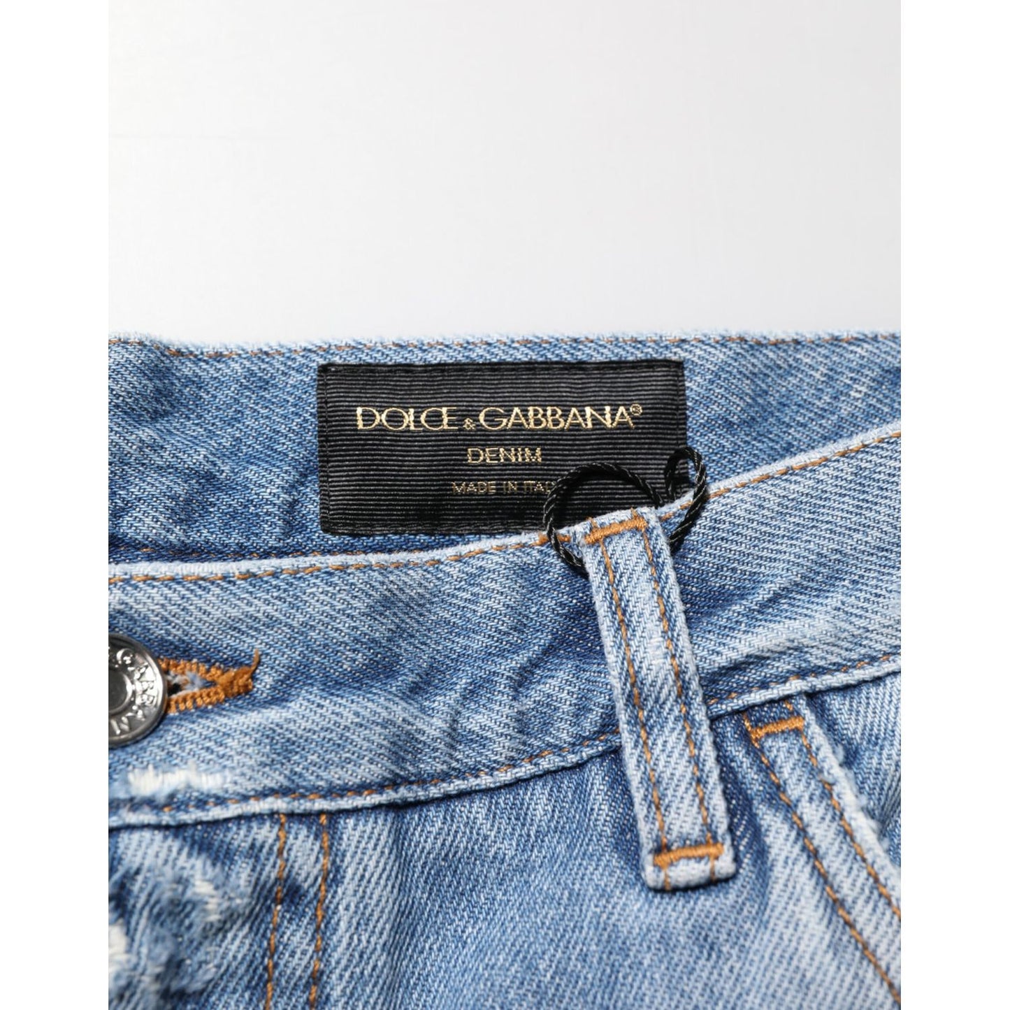 Dolce & Gabbana Blue Distressed Ripped Denim Trouser Jeans with logo plaque and button detail, Italian craftsmanship.