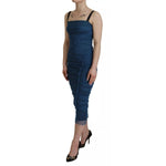 Woman wearing Dolce & Gabbana Blue Mesh Trim Ruched Tulle Sheath Dress; sleeveless bodycon midi, blue with zipper closure, front view.