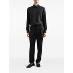Model wearing Dolce & Gabbana DG logo martini jacquard shirt, black silk, front button fastening, classic collar, long sleeves.
