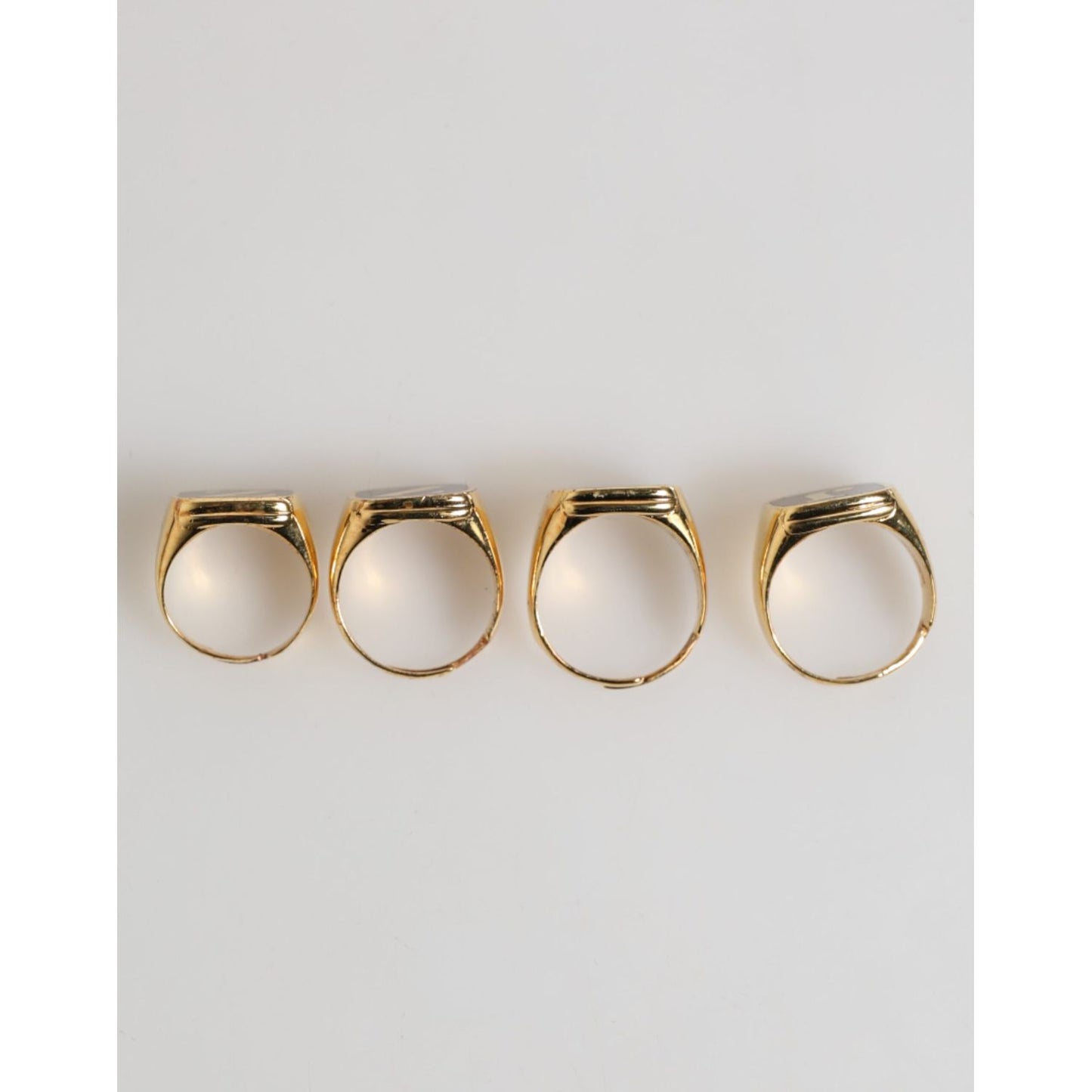 Dolce & Gabbana Gold Tone Brass JAZZ Letter Set 4 Pieces Adjustable Ring showcasing the band's luxurious aesthetic.