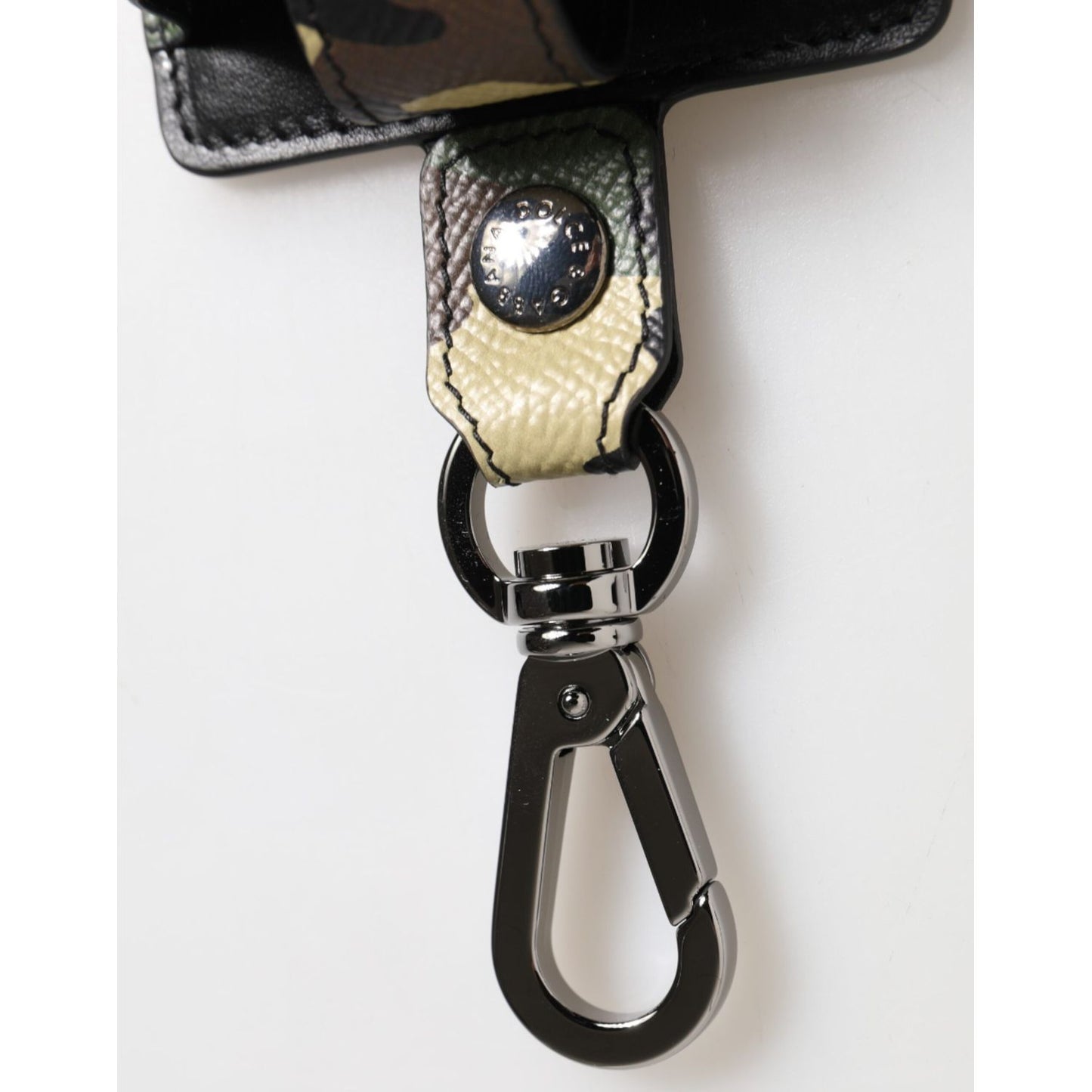 Close-up of Dolce & Gabbana Multicolor Camouflage Leather Metal Accessory Airpods Case showing metal clasp and logo detail.