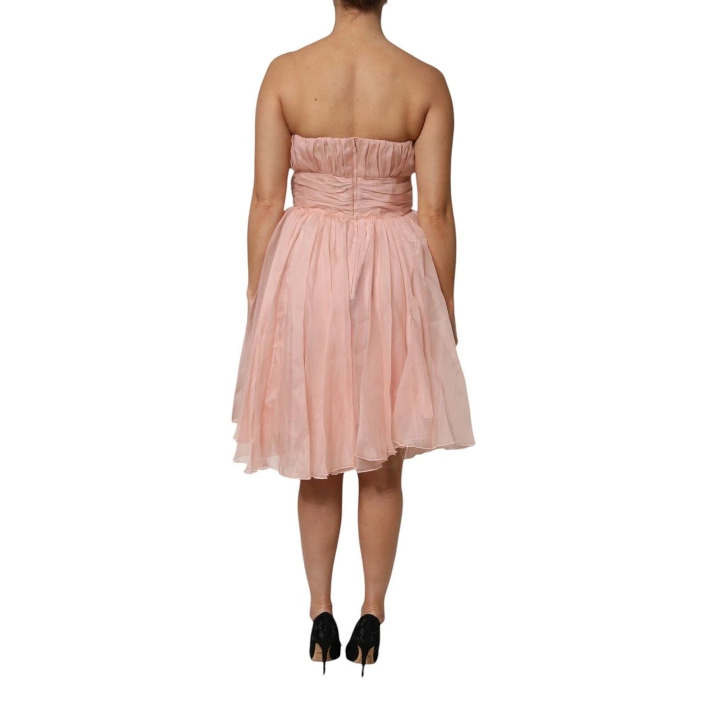 Back view of Dolce & Gabbana Pink Silk Chiffon A-line Pleated Midi Dress on model, showcasing elegant design and craftsmanship.