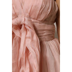 Close-up of Dolce & Gabbana Pink Silk Chiffon A-line Pleated Midi Dress detailing with elegant pleats and luxurious fabric texture.