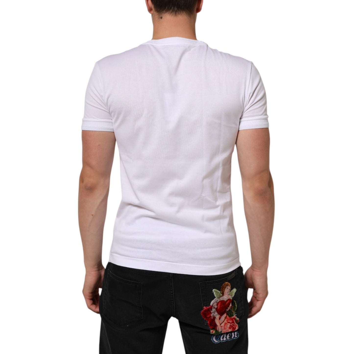 Back view of model wearing Dolce & Gabbana White Cotton Logo Patch Crew Neck T-shirt with black jeans, showcasing logo detail.
