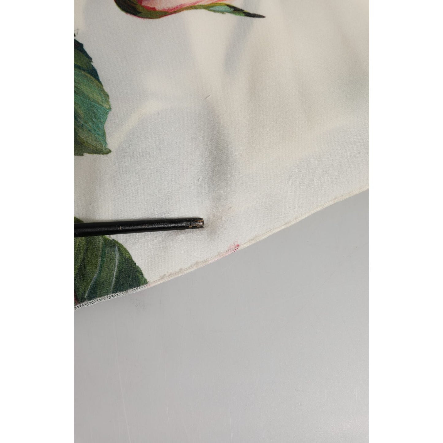 Close-up of the hem detailing on Dolce & Gabbana White Floral Silk One Shoulder Midi Dress showing floral pattern and fabric texture.