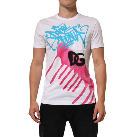 Man wearing Dolce & Gabbana White Graphic Print Cotton Crew Neck T-shirt, featuring bold blue and pink graphics, short sleeves, made in Italy.
