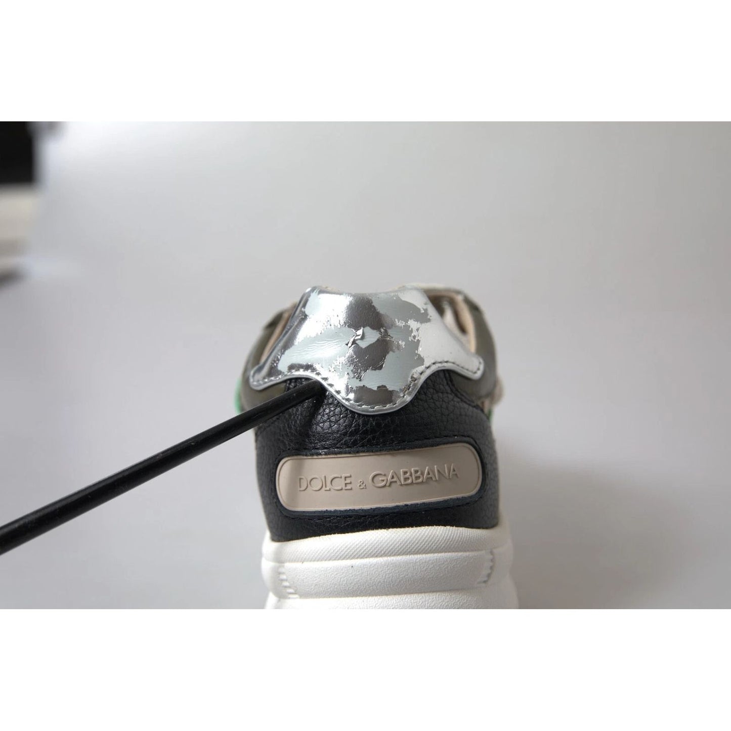 Close-up of the Dolce & Gabbana White Silver Leather Sport DAYMASTER Sneakers with minor heel miscoloration.