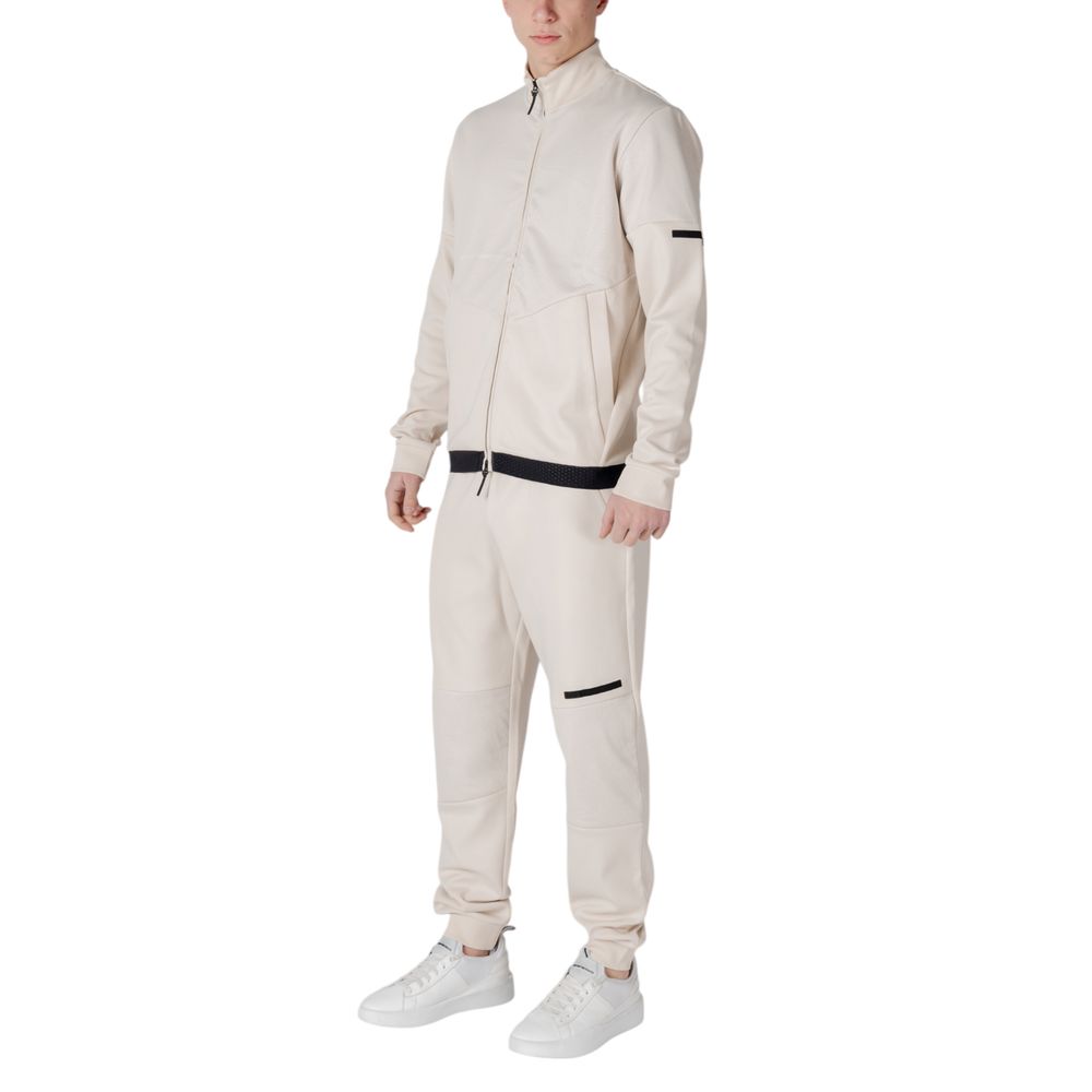 EA7 Emporio Armani Beige Cotton Sweatsuit on model showcasing sporty, modern design with black accents, ideal for style and comfort.