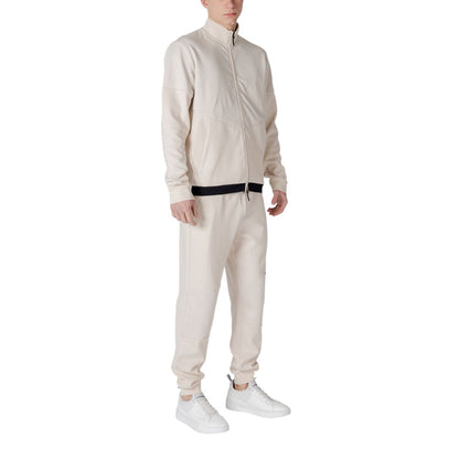 Model wearing EA7 Emporio Armani Beige Cotton Sweatsuit, showcasing a modern and sporty design, ideal for style and comfort.