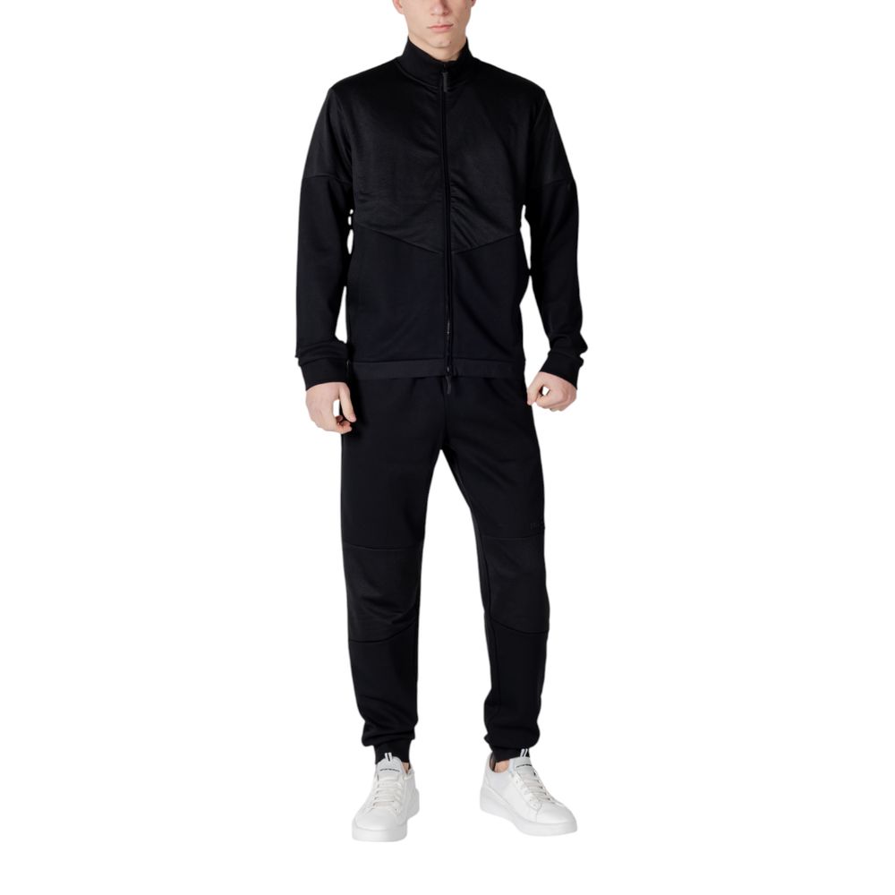 EA7 Emporio Armani Black Cotton Sweatsuit with modern design, worn by a model, perfect for style and comfort in everyday activities.