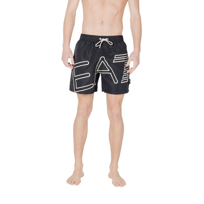 Man wearing EA7 Emporio Armani Black Polyester Swim Shorts with logo and drawstring waistband, perfect for summer beachwear.