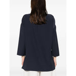 Back view of Emporio Armani cady blouse in oxford blue with drop shoulders and side slits, shown on model.