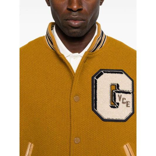 Golden Goose Coats mustard yellow bomber jacket with leather sleeves, varsity letter patch, ribbed trims, and button fastening.