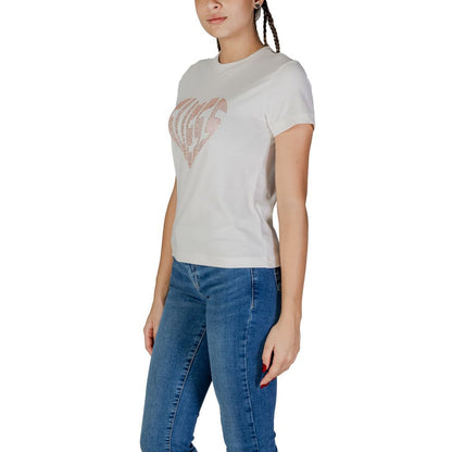 Woman wearing Guess Active Cream Cotton T-Shirt with rhinestone logo, paired with jeans.