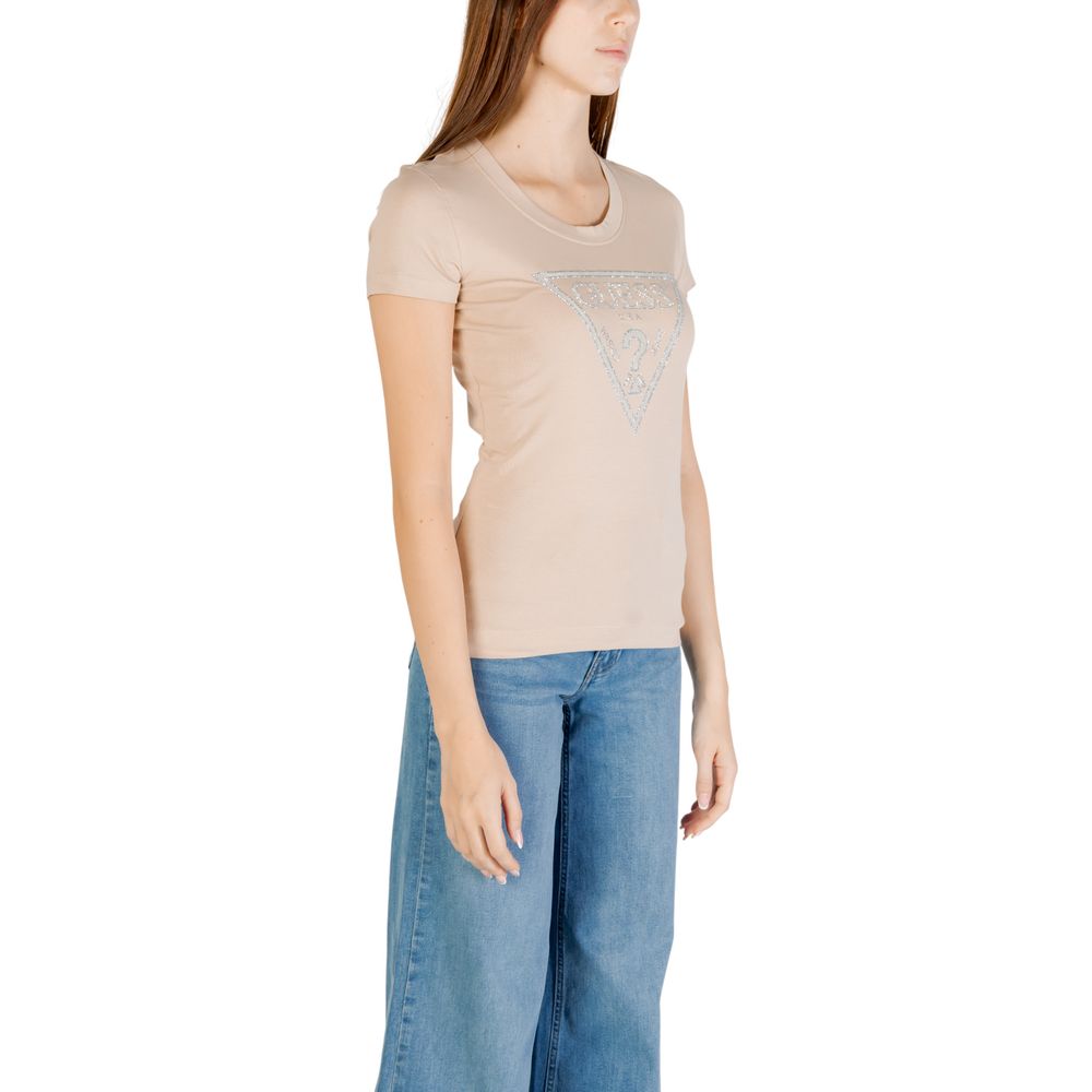 Woman wearing Guess Beige Cotton T-Shirt with shiny triangle logo, slim fit short-sleeved design, styled with classic denim jeans.