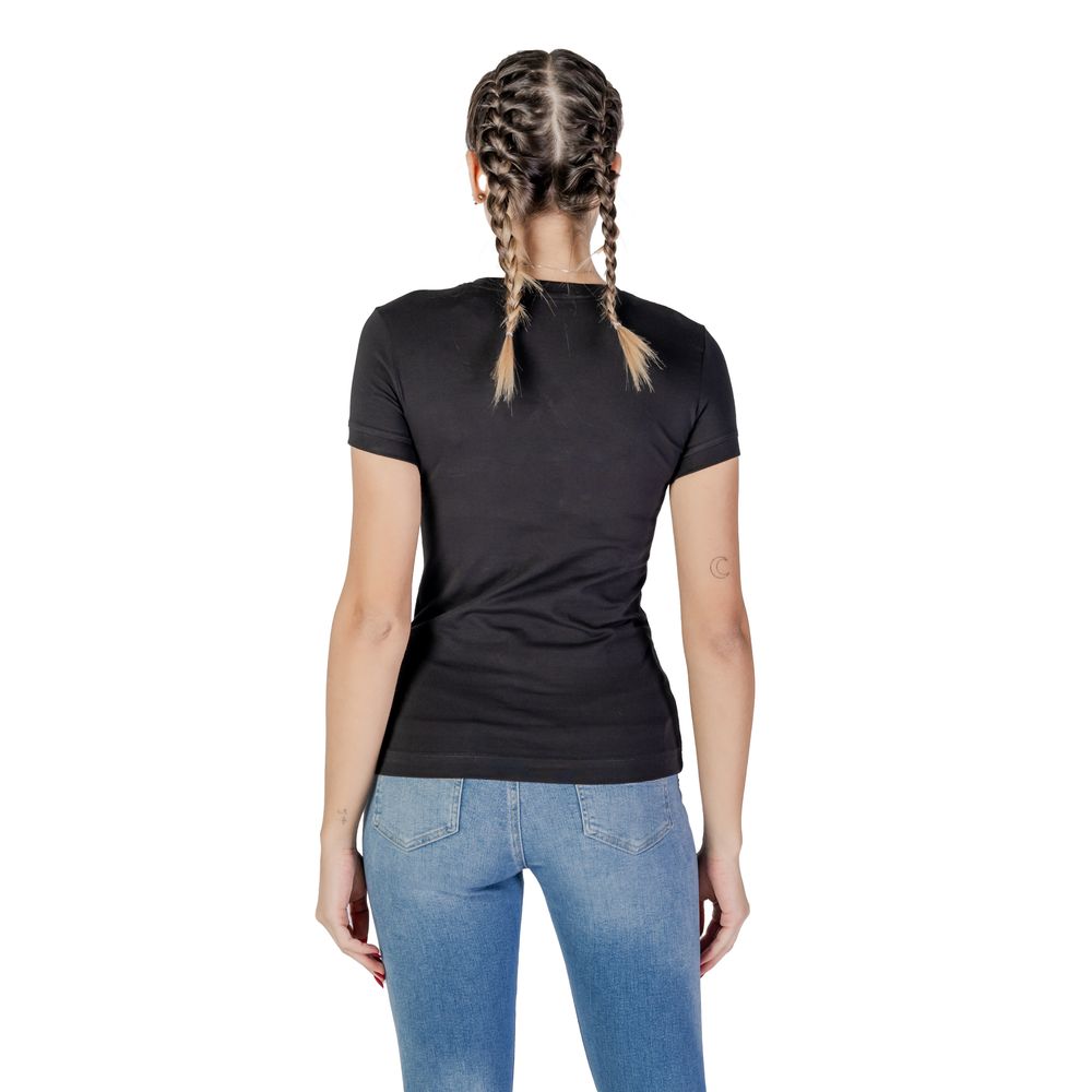 Back view of Guess Black Cotton T-Shirt worn by a woman in jeans, showcasing a comfortable fit and classic design.