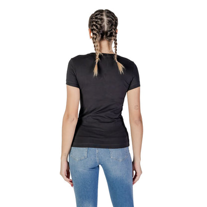 Back view of Guess Black Cotton T-Shirt worn by a woman in jeans, showcasing a comfortable fit and classic design.
