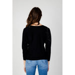 Woman wearing Guess Black Viscose Sportswear sweater with triangle logo.