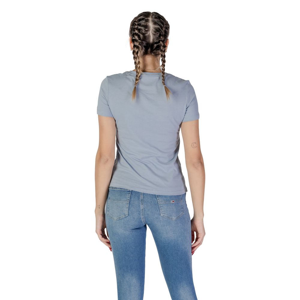 Back view of woman wearing Guess Blue Cotton T-Shirt and jeans, showcasing the shirt's fit and style for casual wear.