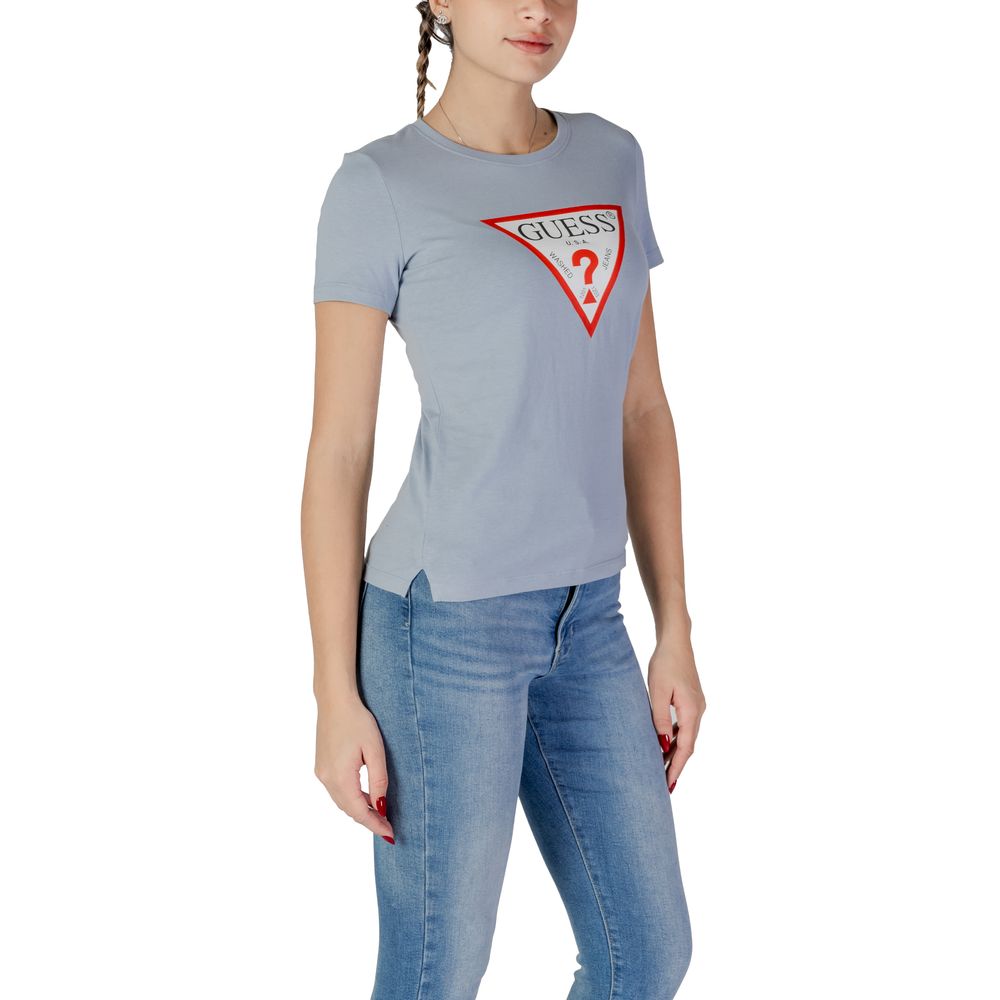 Woman wearing Guess Blue Cotton T-Shirt with logo, paired with jeans. Short-sleeve, crew neck design, casual fashion.