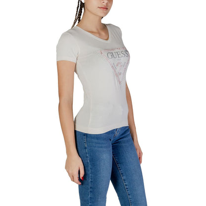 Woman wearing Guess Cream Cotton T-Shirt with V-neckline and stylish design, paired with blue jeans, showcasing casual fashion style.