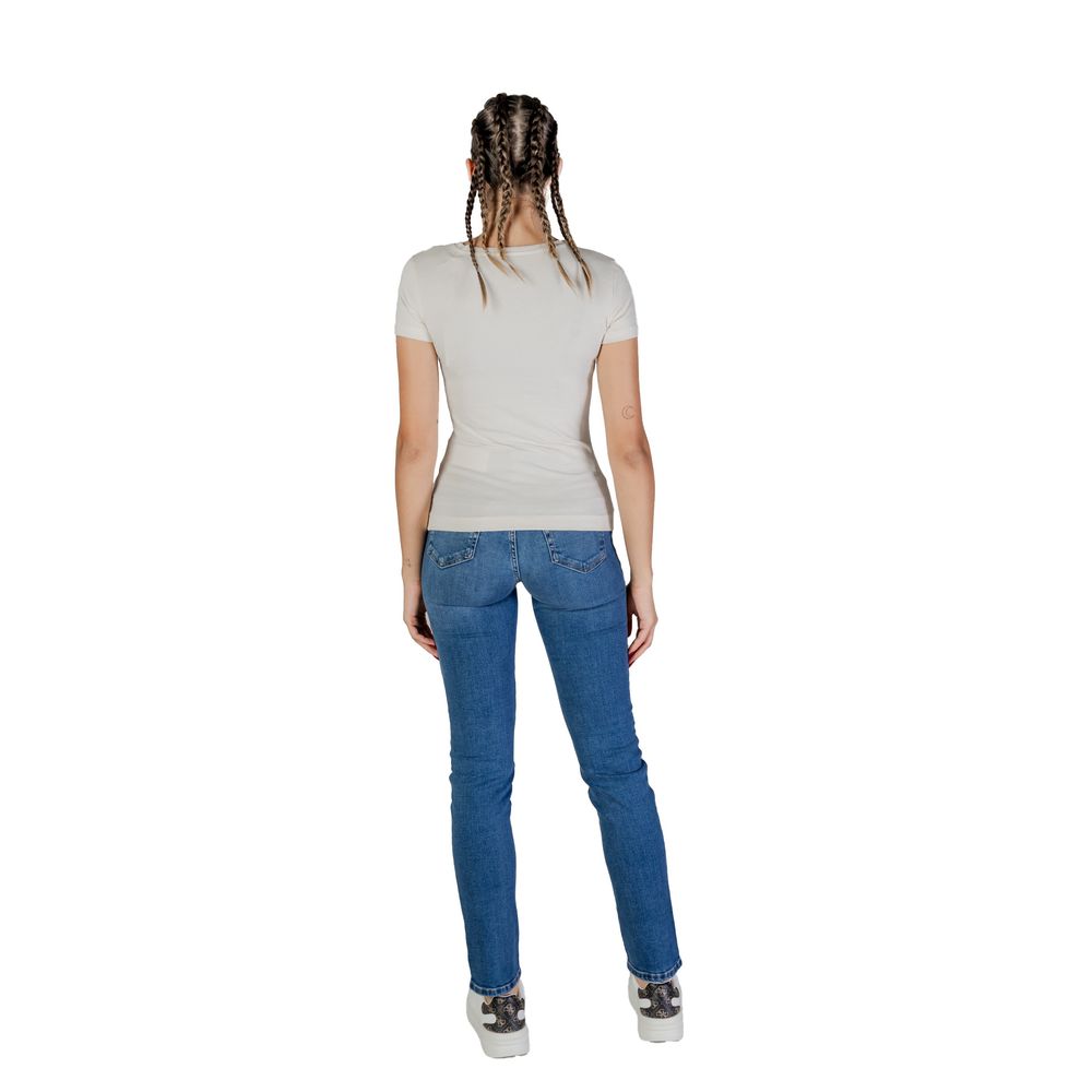 Back view of woman wearing Guess Cream Cotton T-Shirt paired with jeans, showing short sleeves and flattering fit.