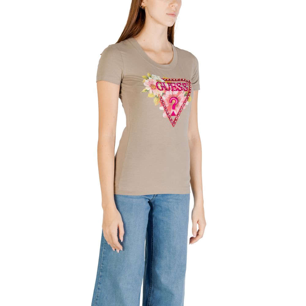 Woman wearing Guess Green Cotton T-Shirt with beaded triangle design, paired with jeans, showcasing summer casual style.