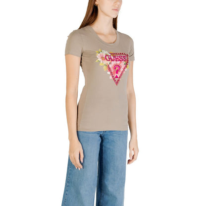 Woman wearing Guess Green Cotton T-Shirt with beaded triangle design, paired with jeans, showcasing summer casual style.