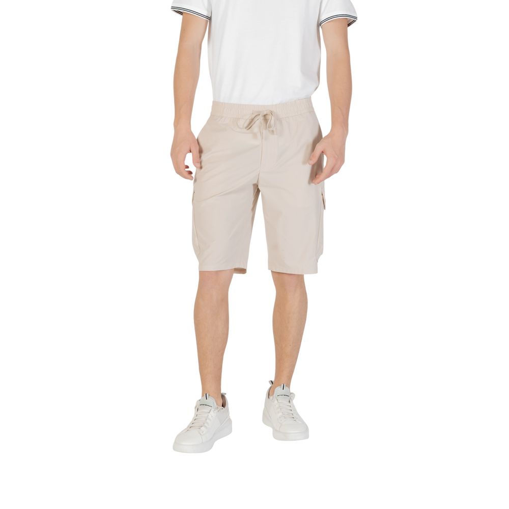 Man wearing Hugo Boss Beige Polyester Bermuda Shorts with elastic waistband and side pockets.