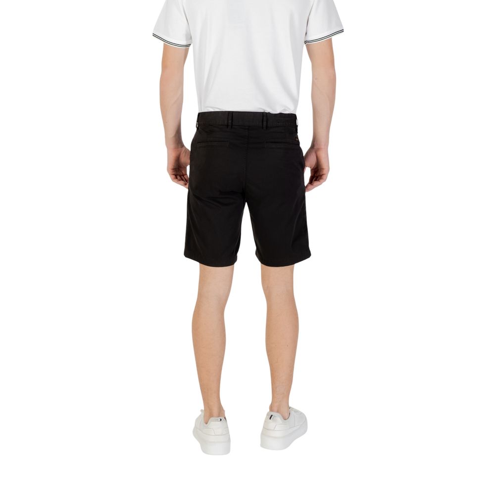 Back view of Hugo Boss Black Cotton Bermuda Shorts on model wearing white sneakers.