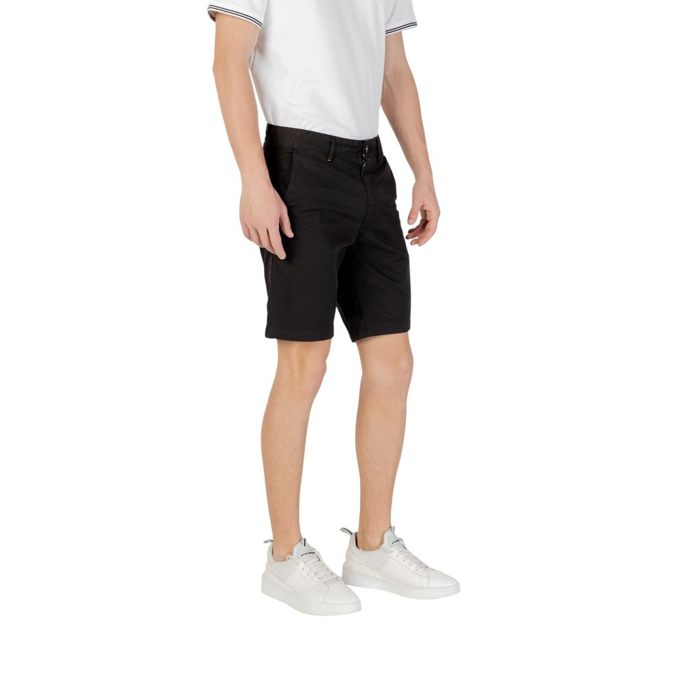 Model wearing Hugo Boss Black Cotton Bermuda Shorts with white sneakers and a casual white shirt.