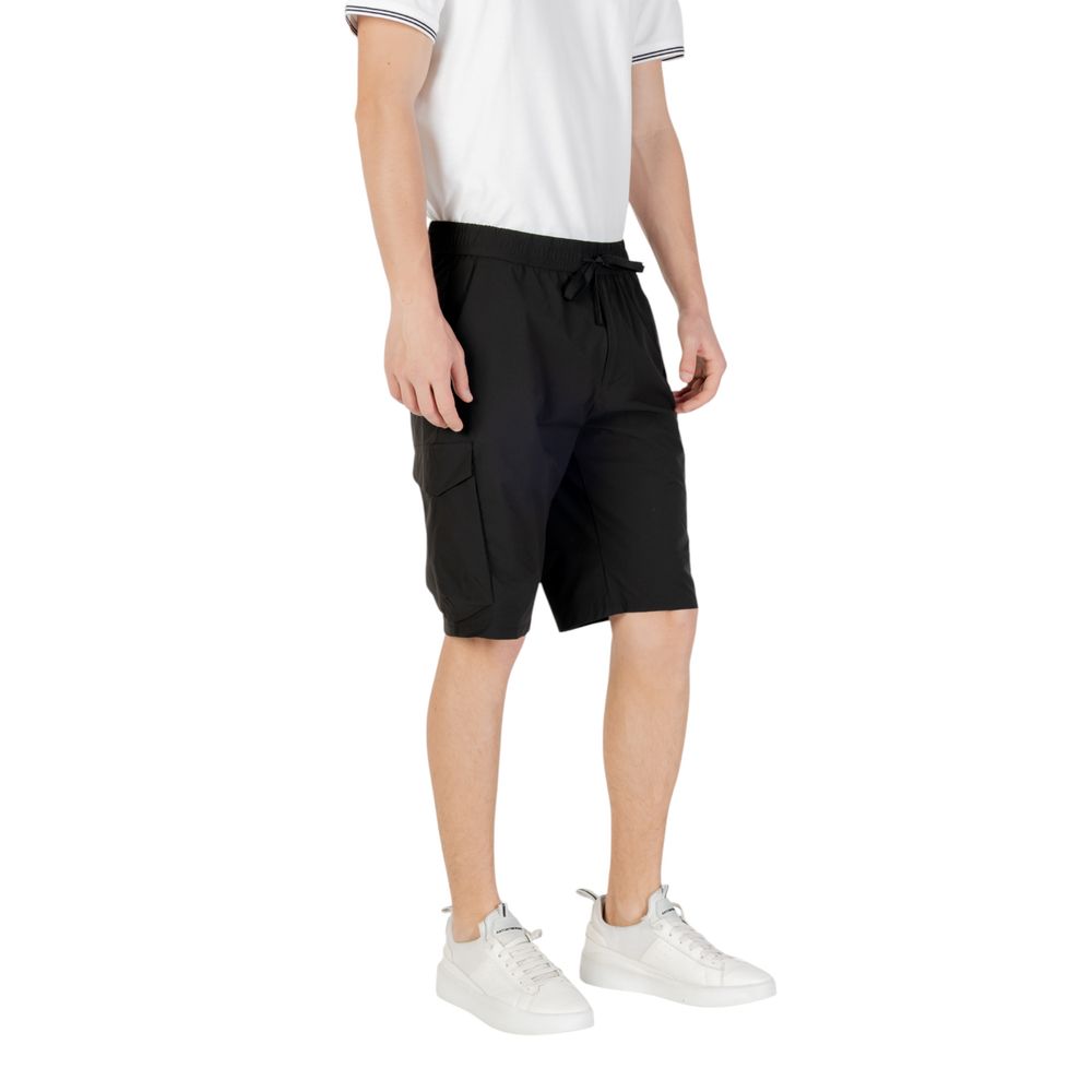 Man wearing Hugo Boss Black Polyester Bermuda Shorts with side pockets and elastic waistband, ideal for casual and functional summer style.