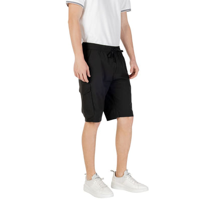 Man wearing Hugo Boss Black Polyester Bermuda Shorts with side pockets and elastic waistband, ideal for casual and functional summer style.