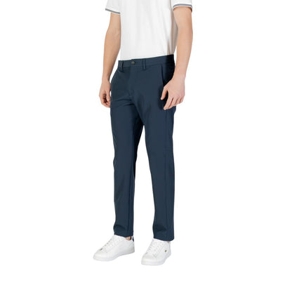 Man wearing Hugo Boss Blue Polyester Skinny Pants with white sneakers and white shirt