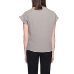 Back view of Jacqueline De Yong Beige Cotton Blouse with short sleeves, made from 80% cotton and 20% recycled cotton, worn by a model.
