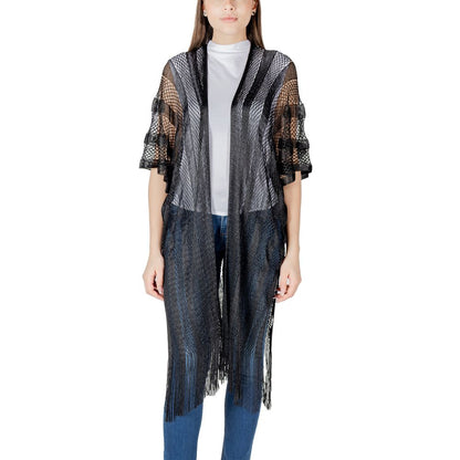 Model wearing Liu Jo Black Polyester Scarf, lurex net poncho, lightweight with fringes, adding bohemian flair to casual outfits.