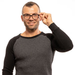 Man wearing Lozza Black Men Glasses Frame with plastic full-rim rectangular lenses, posing in a black and grey sweater.
