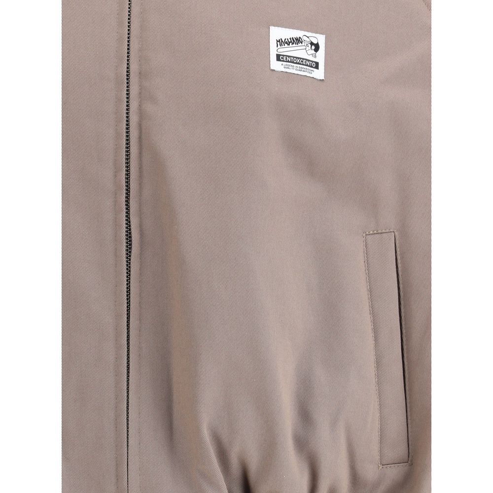 Magliano Bicolor Cotton Full-Length Jacket with logo patch, classic collar, front zipper, and side welt pocket detail.