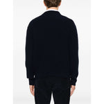 Back view of a person wearing Maison Kitsuné MAISON KITSUNE' Sweaters Blue, featuring oxford blue fisherman's knit and ribbed trim.