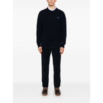 Model wearing Maison Kitsuné MAISON KITSUNE' Sweaters Blue with logo patch and ribbed trim, showcasing oxford blue knit design.
