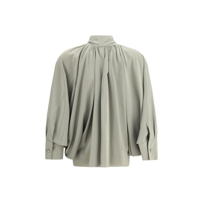 Back view of Max Mara Green Silk Blouse with flowing fit, batwing sleeves, and asymmetrical hem, featuring high cuffs and metal jewel loop detail.