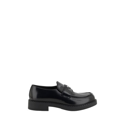 Elegant Prada Black Rubber Platform Loafers with elongated round toe and enameled logo plaque, showcasing modern luxury footwear design.