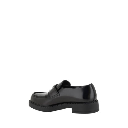 Side view of Prada Black Rubber Platform Loafers with textured sole and iconic logo plaque.