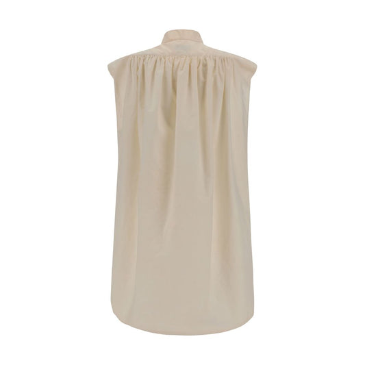Back view of Quira Sleeveless Shirt with mandarin collar and vintage style in beige cotton, highlighting elegant design and side slits.