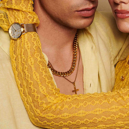 Couple wearing yellow lace, gold chain, and watch showcasing elegance and fashion.
