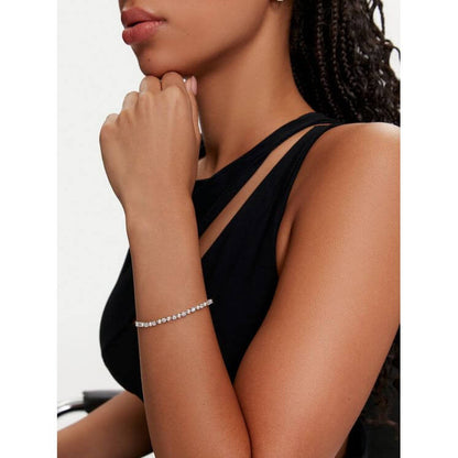 Woman wearing SWAROVSKI Mod. 5689633 Matrix Tennis bracelet with Swarovski Crystal Pearls and Zirconia, showcasing elegant design.