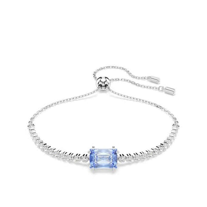 Elegant silver bracelet with blue gemstone centerpiece on white background