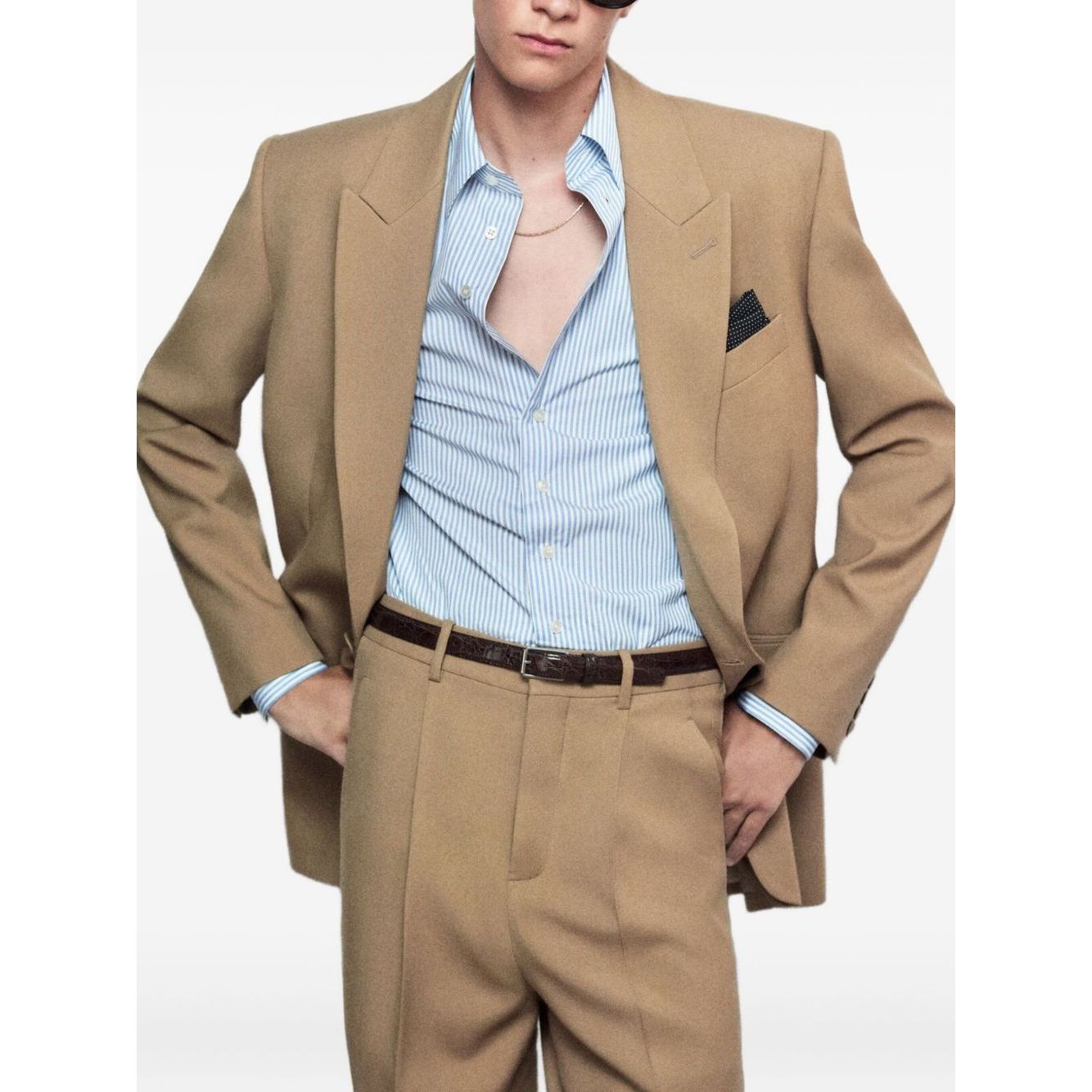Model wearing Saint Laurent Jackets Beige wool single-breasted, front button jacket with chest and side welt pockets, true to size fit.