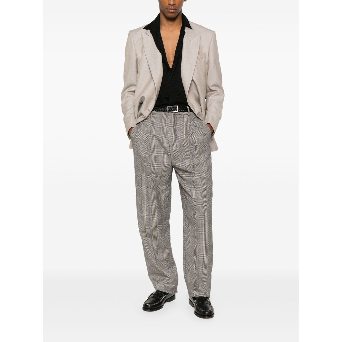 Model wearing light brown Saint Laurent trousers with front button, hook and zip fastening, and two side inset pockets, styled with a blazer.