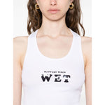 Woman wearing Stella McCartney Top White, a sleeveless racerback tank with 'Slippery When Wet' text.